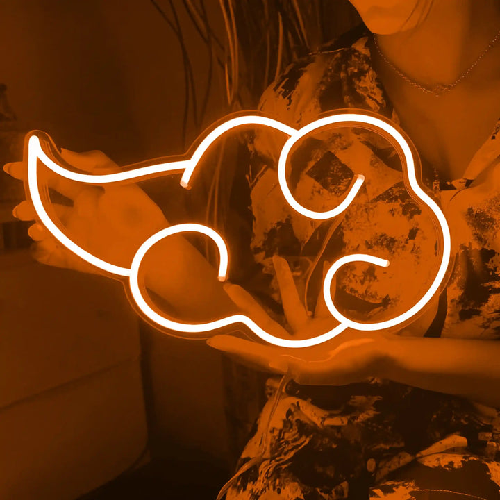 Akatsuki Cloud Neon Sign - A girl holding a orange colored cloud shaped neon sign. - from manhattonneons.com