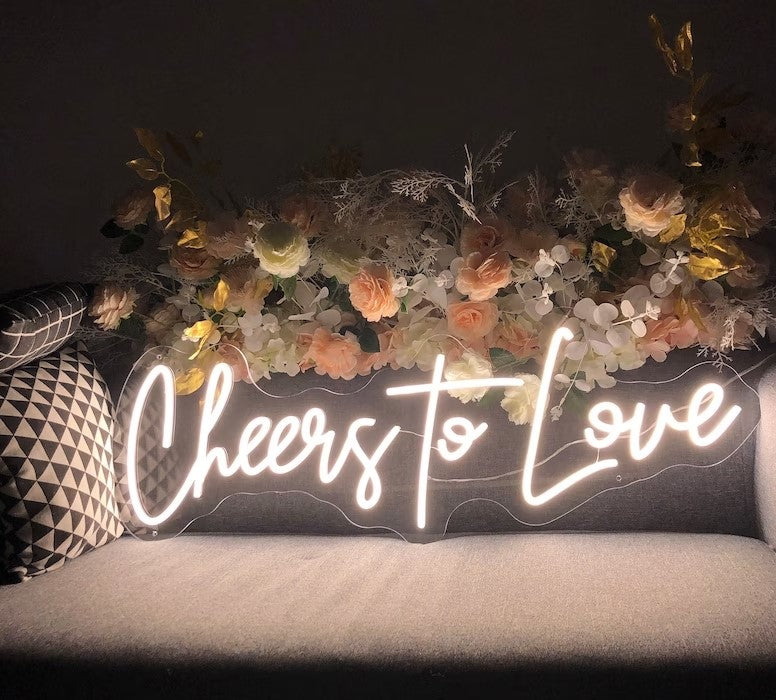 Raise a glass to love with the Cheers To Love wedding neon sign from ManhattanNeons.com, adding a celebratory glow to your big day