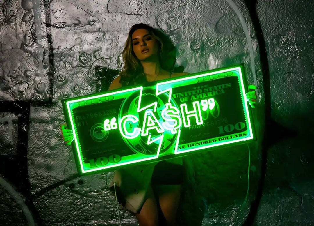 a girl holding a green colored neon sign shaped as a Dollar with the text "CA$H" written on it with UV acrylic artwork of one hundred dollars.