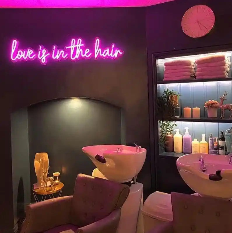 Love-Is-In-The-Hair Trendy Neon Sign, adding a touch of romance and charm to your space - from manhattonneons.com.