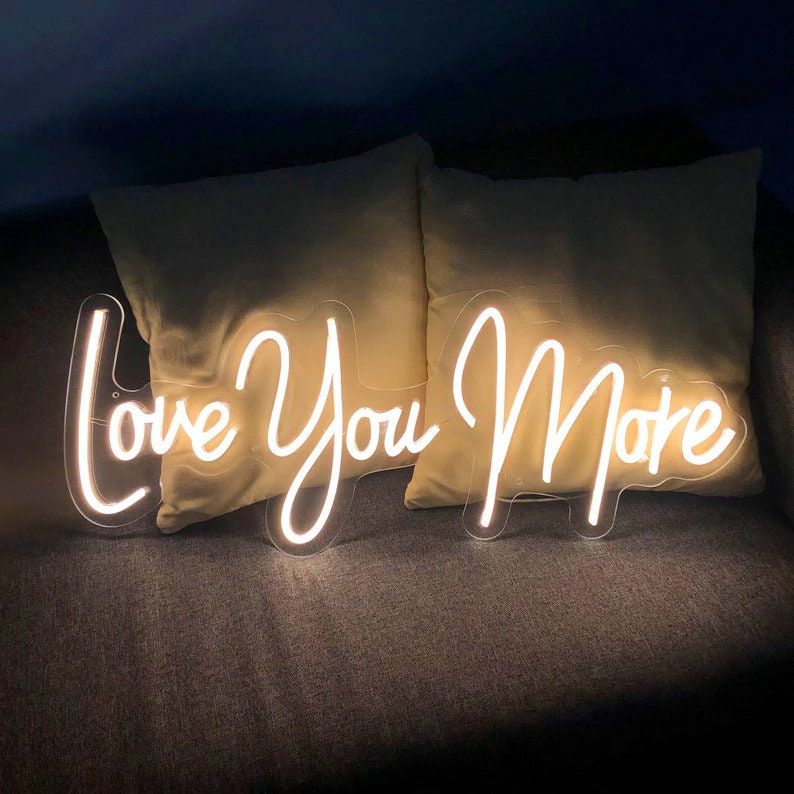 Show your love with the Love You More wedding neon sign by ManhattanNeons.com, radiating warmth and affection.