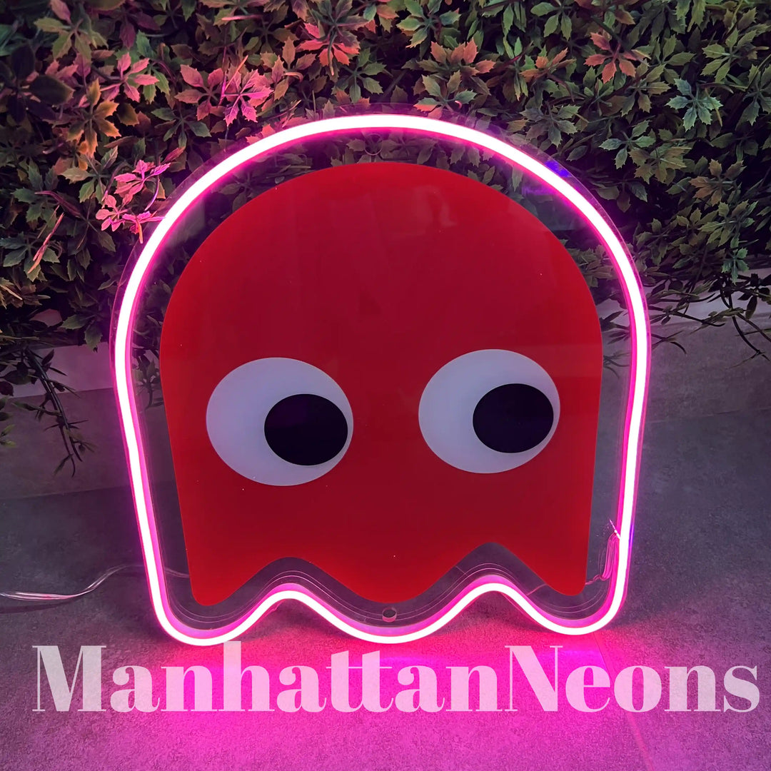 Red and pink colored "Pac Man" UV Printed Neon Artwork placed a on the floor infront of a backdrop