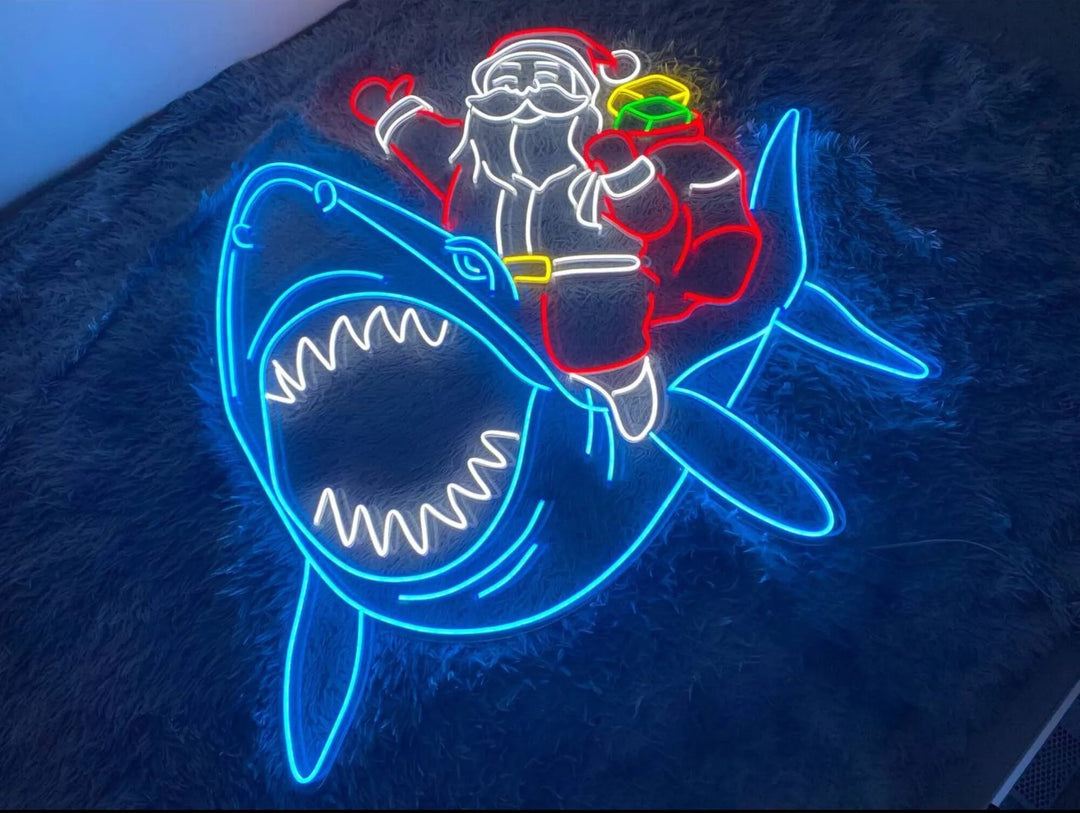 Santa Claus on Shark Merry Christmas Neon Sign by manhattanneons.com - Add a fun and quirky touch to your holiday décor with this Santa on shark neon sign.