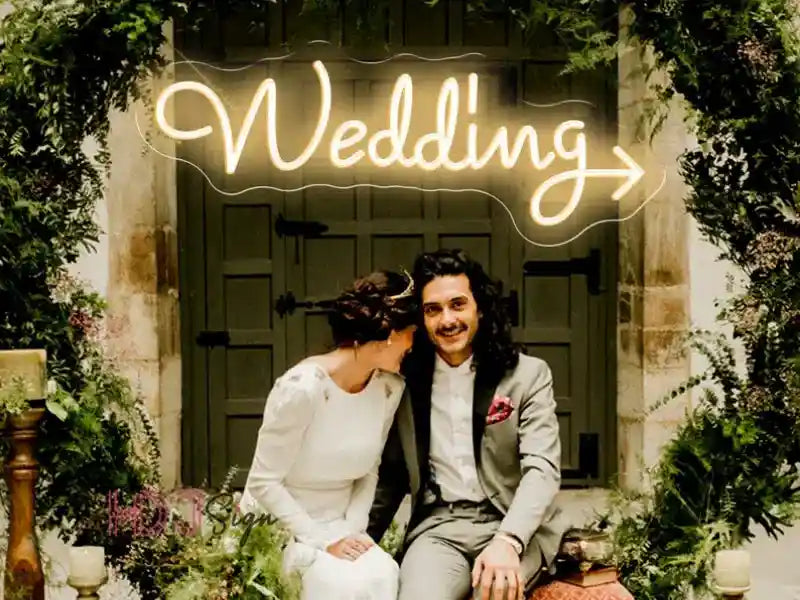 the wedding neon sign from ManhattanNeons.com looks stunning while adding a special touch to the couple's moment.