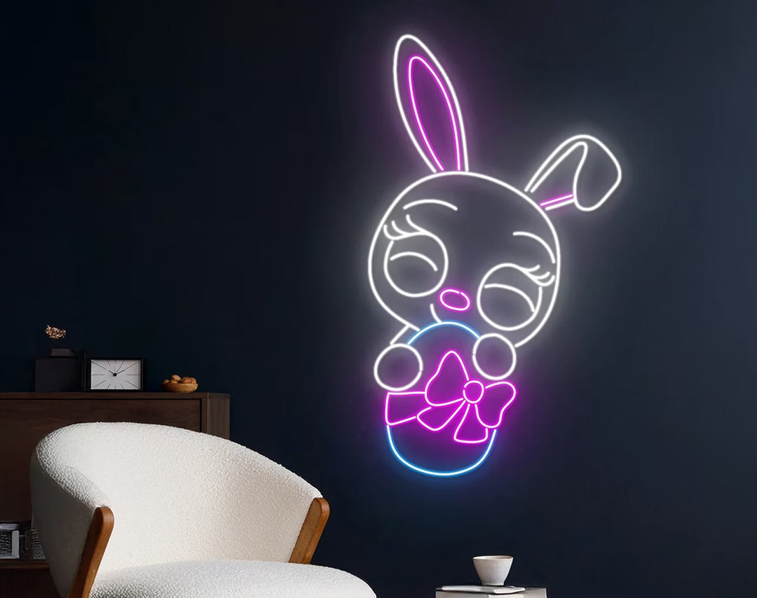 Cute Rabbit with Egg Easter Neon Sign by manhattanneons.com – A charming Easter bunny holding an egg.